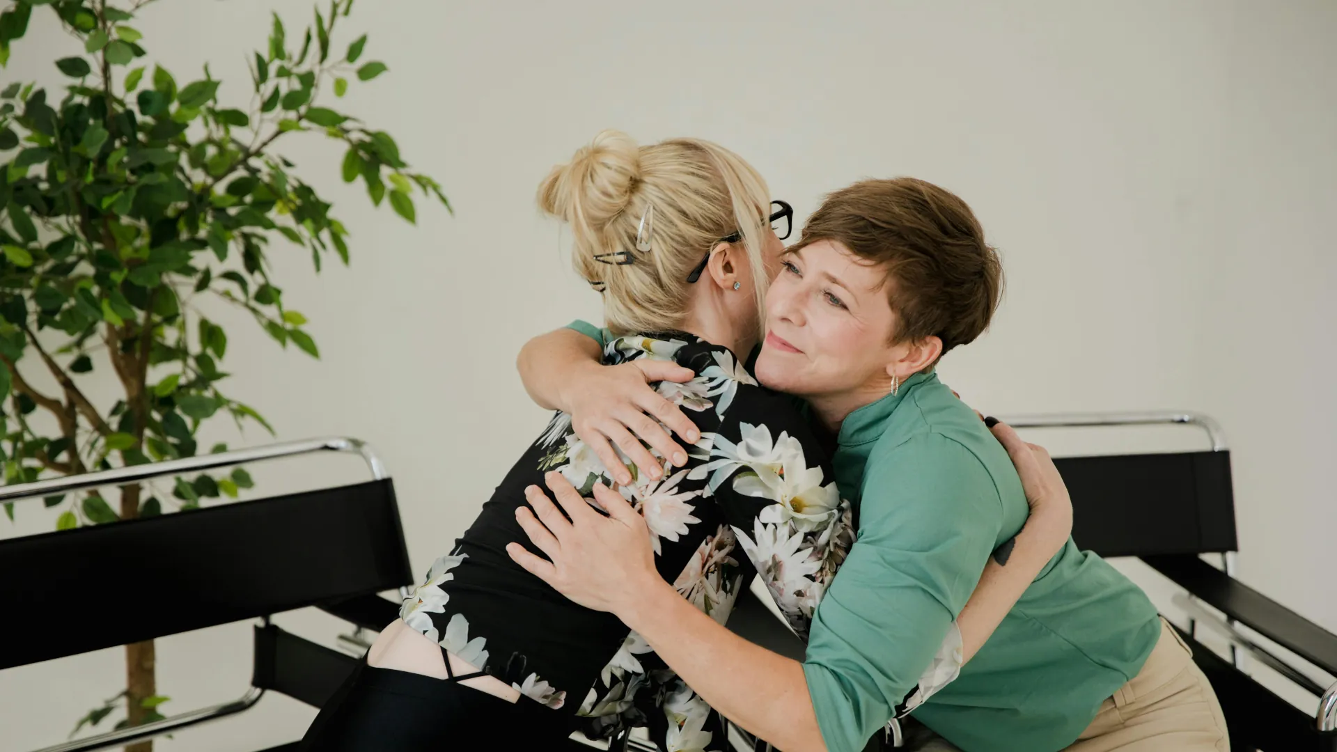 A lady hugs her counsellor to thank her for her help.