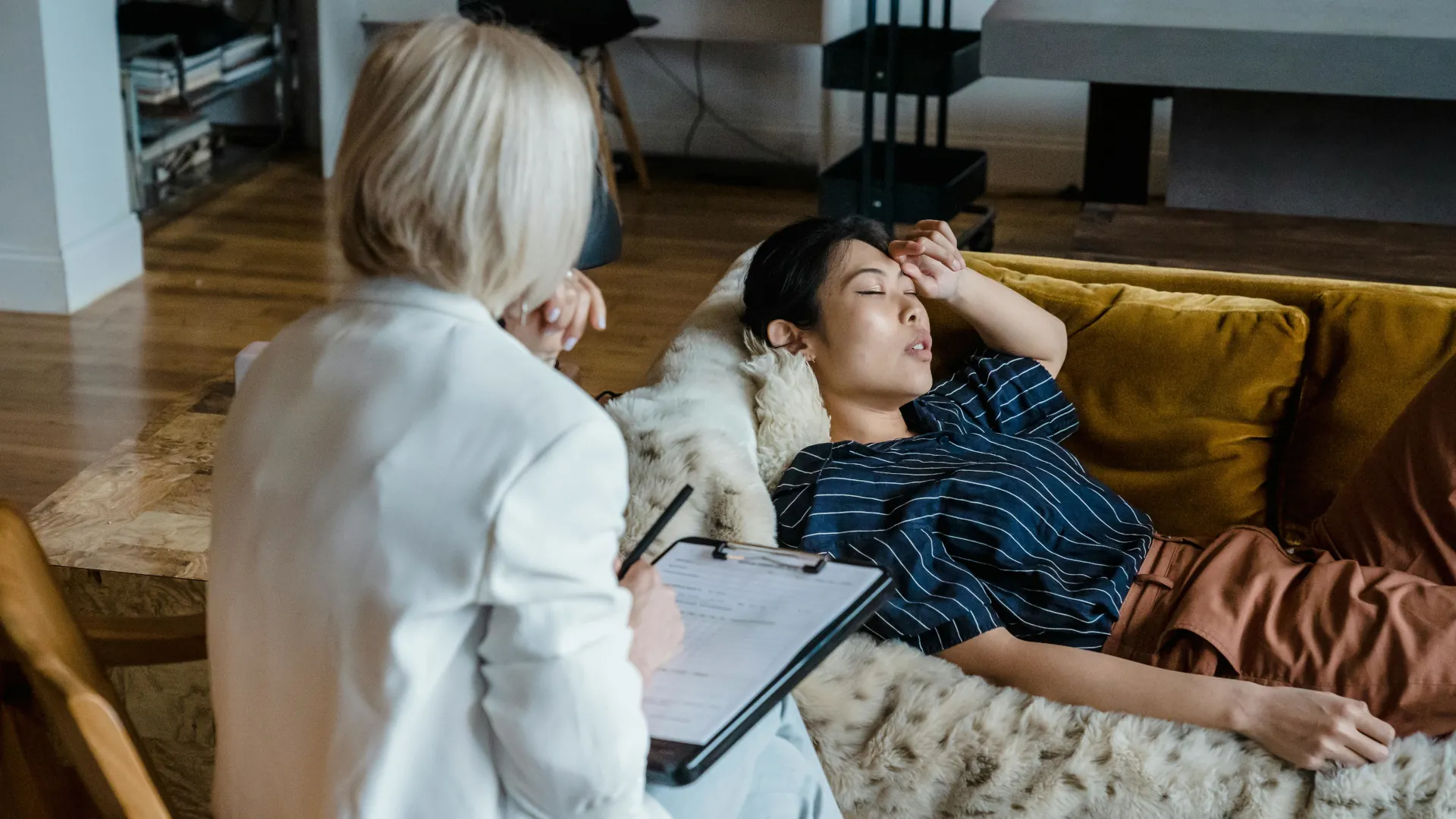 A young woman relaxes her mind during a hypnotherapy session.