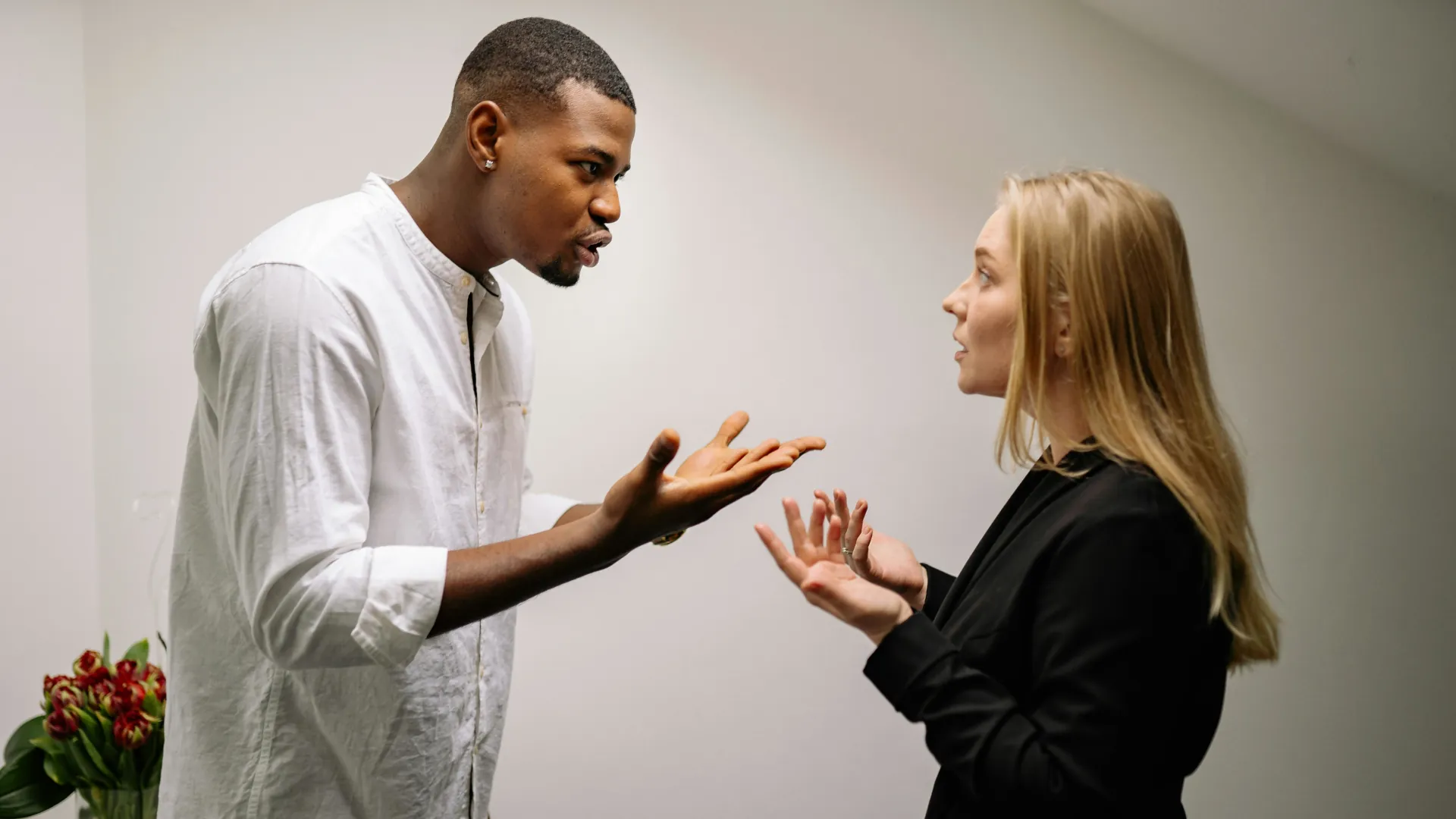 A couple are trying to talk an issue in their relationship through but it doesn't appear to be working and tensions appear high.