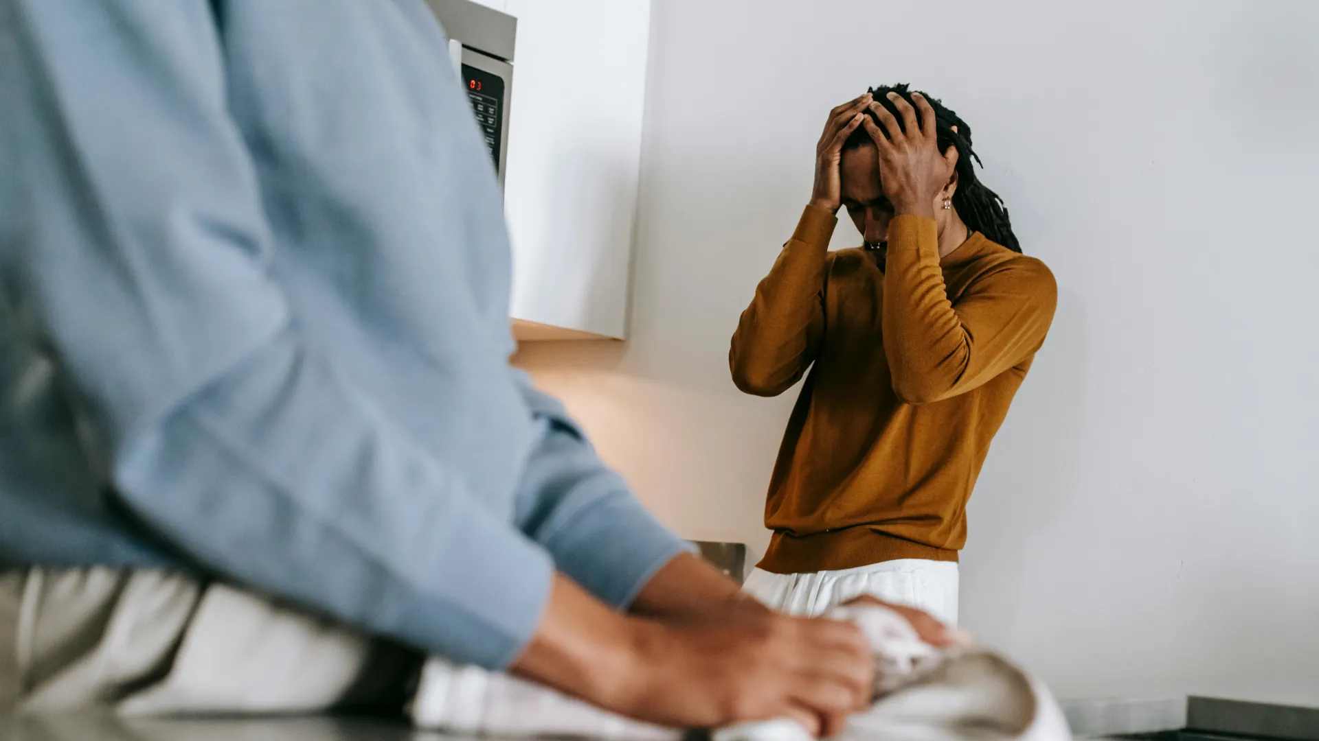 A male appears distraught as his partner is opening up about her feelings on their relationship.